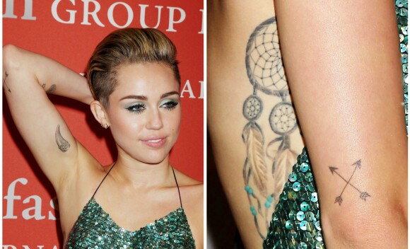 TATOVERT: Miley Cyrus har over 20 ulike tatoveringer rundt om på kroppen. Her viser hun frem noen av dem på rød løper i 2013. Foto: NTB scanpix TATOVERT: Miley Cyrus har over 20 ulike tatoveringer rundt om på kroppen. Her viser hun frem noen av dem på rød løper i 2013. Foto: NTB scanpix
